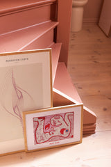 Art posters by pink staircase
