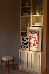 Abstract art posters on bookshelf
